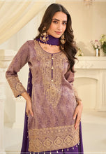 Load image into Gallery viewer, Woman wearing a purple and gold embroidered traditional outfit indoors.