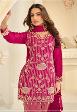 Load image into Gallery viewer, Woman wearing a pink embroidered traditional outfit indoors.