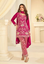 Load image into Gallery viewer, Woman wearing a pink traditional outfit with intricate patterns in a decorated room.