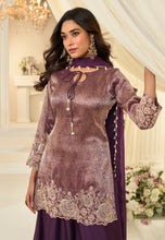 Load image into Gallery viewer, Woman wearing a purple embroidered outfit in an elegant interior setting
