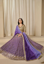 Load image into Gallery viewer, Woman wearing a traditional outfit with a purple Lehenga