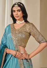 Load image into Gallery viewer, Woman wearing a traditional outfit with a gold blouse.