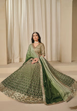 Load image into Gallery viewer, Woman wearing a green and gold traditional outfit 

