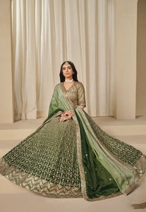 Woman wearing a green and gold traditional outfit 