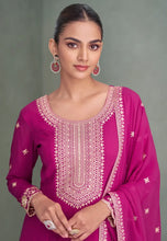 Load image into Gallery viewer, Woman wearing a pink embroidered traditional outfit 

