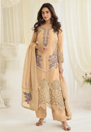 Model wearing a cream Simar silk Pakistani-style embroidered kurta set with colorful threadwork, matching palazzo pants, and a coordinated dupatta.