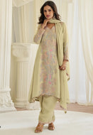 Model wearing a pastel pistachio green Simar silk Pakistani-style embroidered kurta set with beadwork, matching palazzo pants, and a coordinated dupatta.