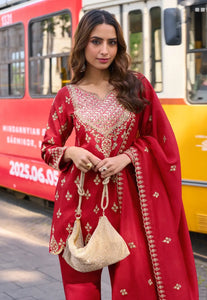 Woman in a red traditional outfit with gold embroidery