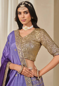 Woman wearing a traditional gold and purple Lehenga