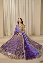 Load image into Gallery viewer, Woman wearing a traditional outfit with a purple Lehenga
