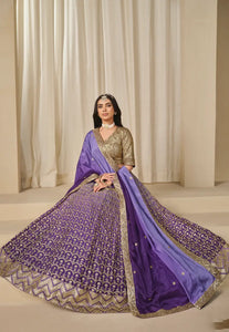 Woman wearing a traditional outfit with a purple Lehenga