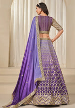 Load image into Gallery viewer, Woman wearing a purple and gold traditional Lehenga
