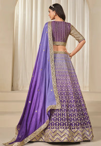 Woman wearing a purple and gold traditional Lehenga