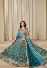 Load image into Gallery viewer, Woman wearing a traditional teal and gold lehenga
