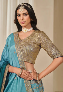 Woman wearing a traditional outfit with a gold blouse.