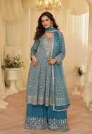 Woman wearing teal blue heavy embroidered georgette kurta palazzo set with matching dupatta, festive ethnic outfit for weddings and celebrations