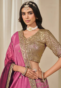 Fashneo pink and gold lehenga choli with intricate gold embroidery and matching accessories